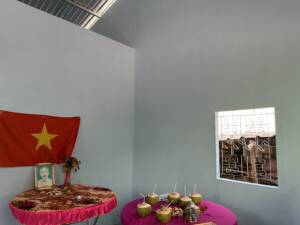Charity House 51 for Kis Promise with table and chairs and Vietnamese flag.